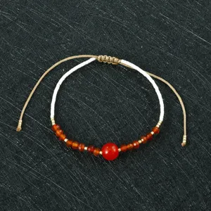 Handmade woven beaded bracelet featuring Miyuki seed beads and red stones with adjustable cord.