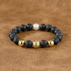 Men's beaded bracelet featuring black lava stone, shiny gold metal beads, and a white pearl accent.