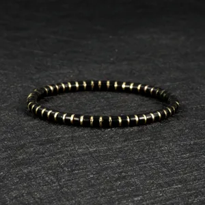Detailed shot of a black obsidian and metal beaded bracelet, elegant boho style jewelry.