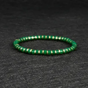 Green beaded stretch bracelet detail view, bohemian style metal spacer handmade jewelry.