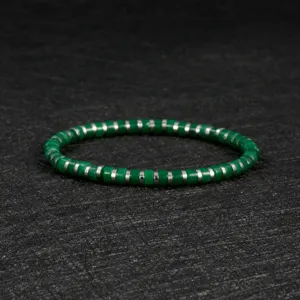Green beaded bracelet detail shot, elegant gemstone style with metallic spacers for women.