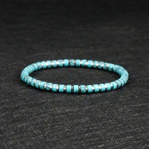 Turquoise and silver disc beads bracelet detail shot, bohemian style elastic beaded jewelry.