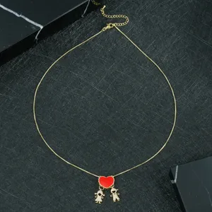 Gold heart pendant necklace featuring cute boy and girl charms for sweet couple fashion style.