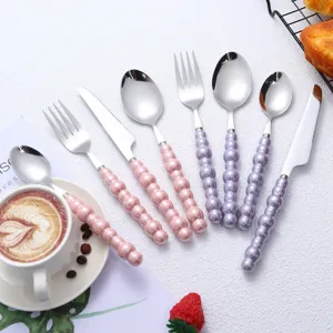Luxury stainless steel cutlery set with elegant pearl beaded handles for western dining table.