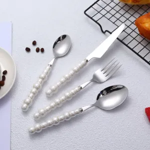 Stainless steel cutlery set with elegant pearl handle design for western dining table use.