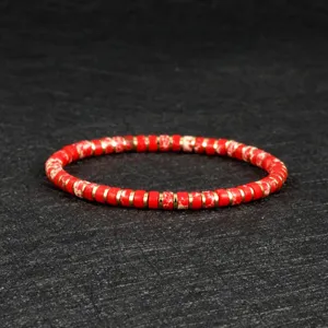 Red stone and gold bead elastic bracelet detail, bohemian style jewelry for women and couples.