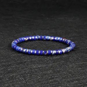 Closeup of blue and white stone disk bead bracelet with metallic spacers for wrist detail.