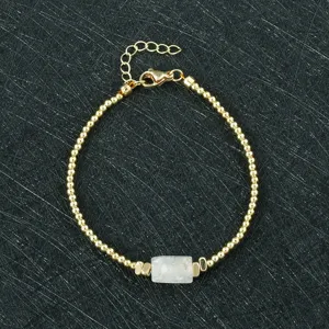 Details of natural white crystal raw stone gold beaded adjustable bracelet close-up.
