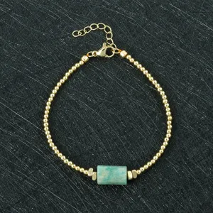 Elegant gold beaded bracelet with green natural stone and adjustable extension chain.
