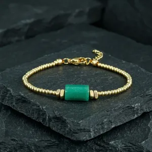Vintage gold beaded bracelet with green stone cylinder pendant, adjustable length, elegant jewelry.