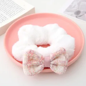 Plush hair scrunchie with pink tweed bow detail, soft autumn winter hair accessory for women.