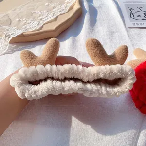 Detailed close-up of soft coral fleece deer antler headband, plush texture for daily makeup.