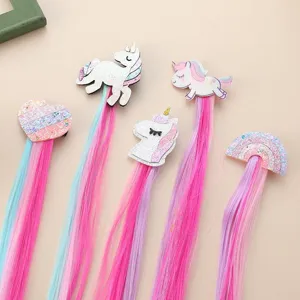 Kids colorful hair extension clips with cute unicorn and rainbow designs for styling.