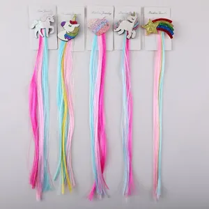 Detailed view of colorful children hair extension clips featuring cute unicorn and star designs.