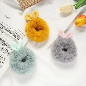 Plush rabbit ear hair scrunchies detail shot, fluffy winter hair rope in multiple colors.