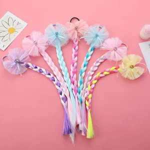 Detailed view of colorful synthetic hair braids with mesh bows, cute kids hair accessories.
