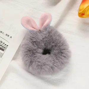 Grey plush bunny ear hair scrunchie detail view, soft faux fur elastic hair band accessory.