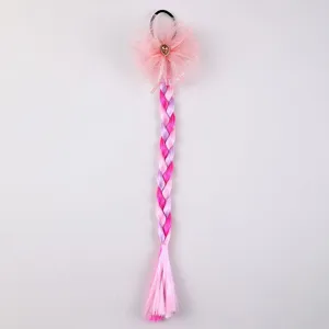 Close-up detail of children colorful hair braid extension with pink mesh bow and sparkling rhinestone.