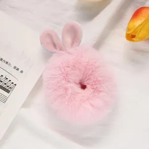 Soft pink plush bunny ear hair scrunchie detailed view, cute fuzzy hair tie accessory for women.