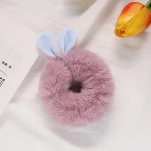 Close up detail of cute plush rabbit ear hair scrunchie, soft fluffy material for autumn winter.