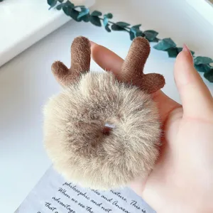 Plush reindeer antler hair scrunchie detail view, soft faux fur elastic hair tie for cute styles.