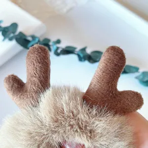 Fluffy plush reindeer hair scrunchie detail showcase, cute winter furry hair tie accessory.