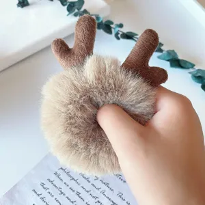 Detailed view of the cute plush reindeer antler hair scrunchie, soft fluffy texture.