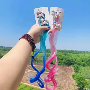 Detailed shot of colorful unicorn hair extension clips featuring cute designs for children.