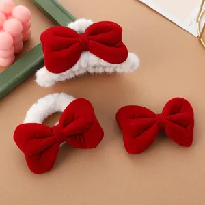 Detail shot of a plush red velvet bow hair clip set, showcasing soft texture and cute style.