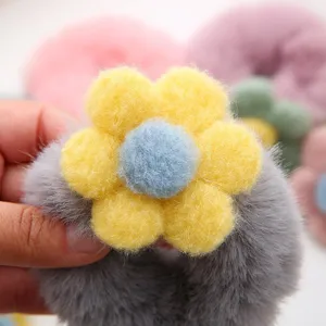 Cute plush flower hair scrunchie, fluffy winter hair tie with candy colors for sweet styling.