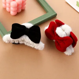 Close-up of plush bow hair claws with soft white faux fur trim, sweet detail shot.