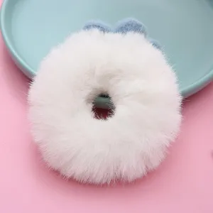 Fluffy white plush hair scrunchie with blue flower detail, cute autumn winter hair tie.