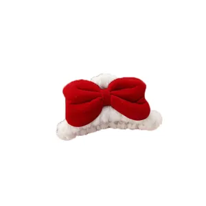 Red velvet bow plush hair claw clip detail view, sweet winter hair styling accessory.