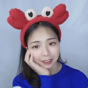 Cute red crab plush headband detail view, soft fuzzy fabric for daily makeup and face washing.