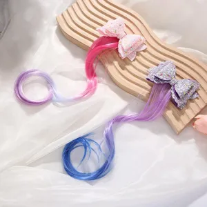 Close-up detail of cute kids glitter bow hair clip with colorful gradient hair extensions.