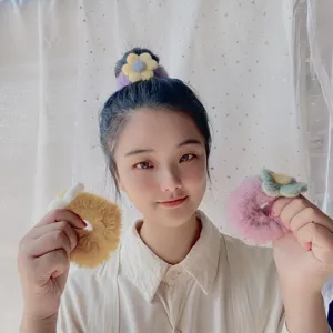 Detailed view of sweet candy color plush flower hair scrunchie, soft fuzzy texture for autumn.