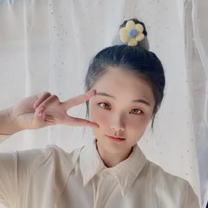 Close-up detail of the cute plush flower hair scrunchie, soft texture and sweet style.