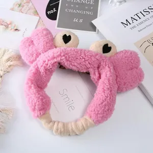 Close-up detail of the cute pink plush crab headband, soft fluffy texture for daily wash face.
