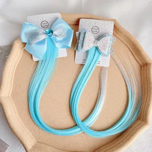 Detailed view of handmade double bow hair clip with blue gradient synthetic hair extensions.