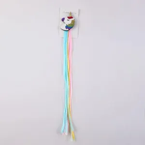 Detail view of the colorful unicorn hair clip with long pastel braids, perfect for kids dress up.
