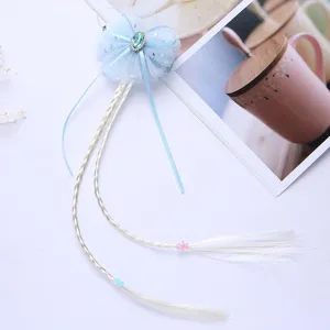 Kids wig hair clip with blue mesh bow and braided hair extensions for princess dress up detail view.