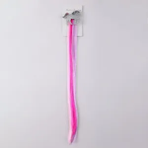 Detailed view of children colorful hair extension clip with cute sparkly unicorn design and strands.