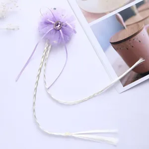 Kids wig hair clip with purple tulle bow and long white braided hair extensions detail view