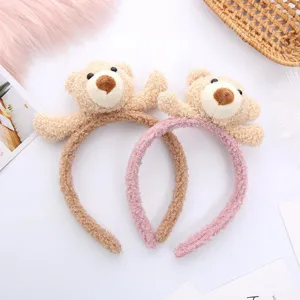 Cute cartoon bear plush doll detail shot showing soft lamb wool texture and sweet pink brown headband.