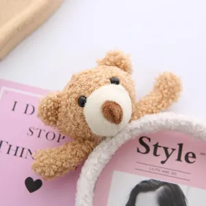 Cute plush bear headband detail shot, soft lamb wool cartoon hair hoop for sweet girls daily wear.