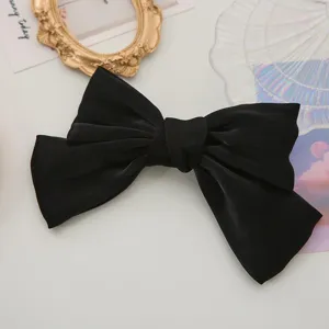 Elegant black satin bow hair clip for women, sweet hair accessories and ponytail styling.
