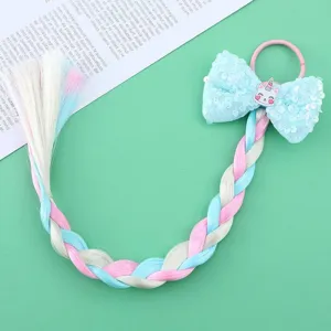 Detailed view of colorful kids wig braid hair tie with sequin bow and cute unicorn charm.