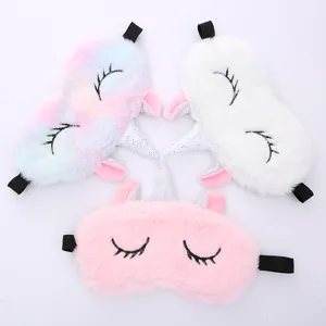 Plush unicorn sleep mask detail view, soft material, cute embroidery and sparkling horn.