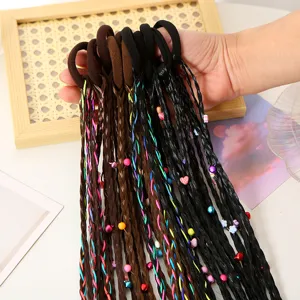 Close-up detail of colorful braided hair extensions with beads and heart charms for kids.
