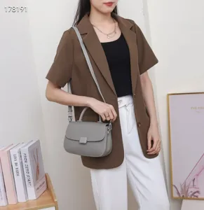 Vintage grey leather top handle crossbody bag for women, elegant flap shoulder fashion purse.